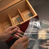 Person placing cigars into a Boveda Humidor Bag.