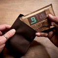 Boveda 49% RH being placed inside a protection case