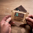 Boveda 49% RH being removed from plastic overwrap.