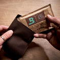 Boveda 49% RH being placed inside a fabric holder.