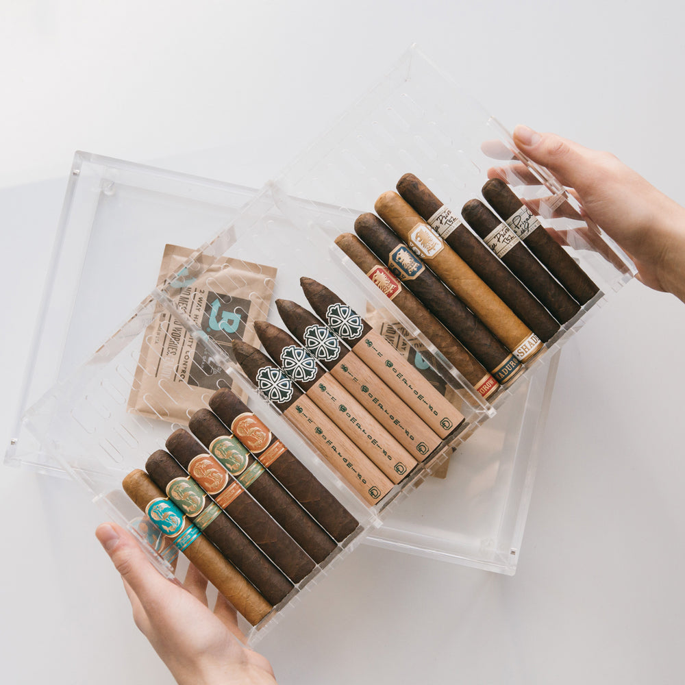 Cigars in an acrylic humidor.