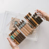 Cigars in an acrylic humidor.